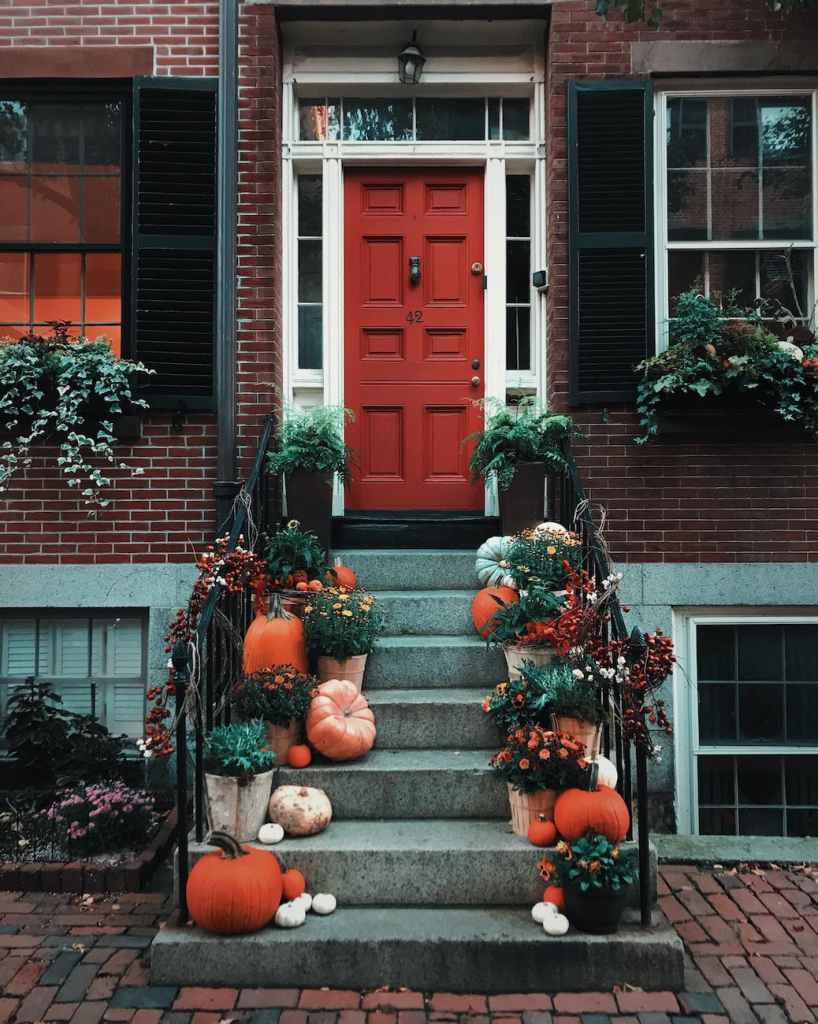 pumpkins on stairs in front of a door