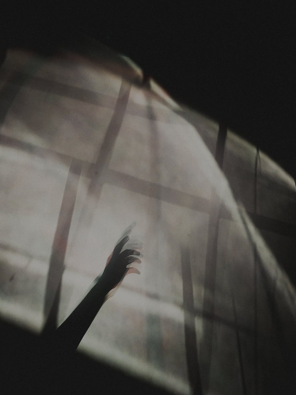 blurred silhouette of a hand reaching out