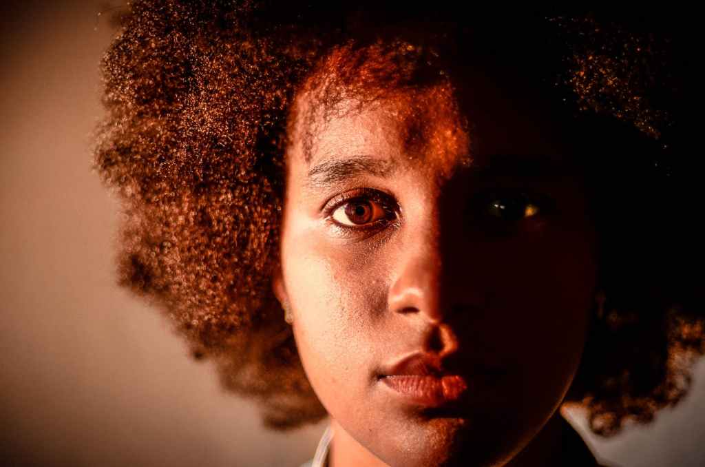 closeup photo of a woman with afro textured hair